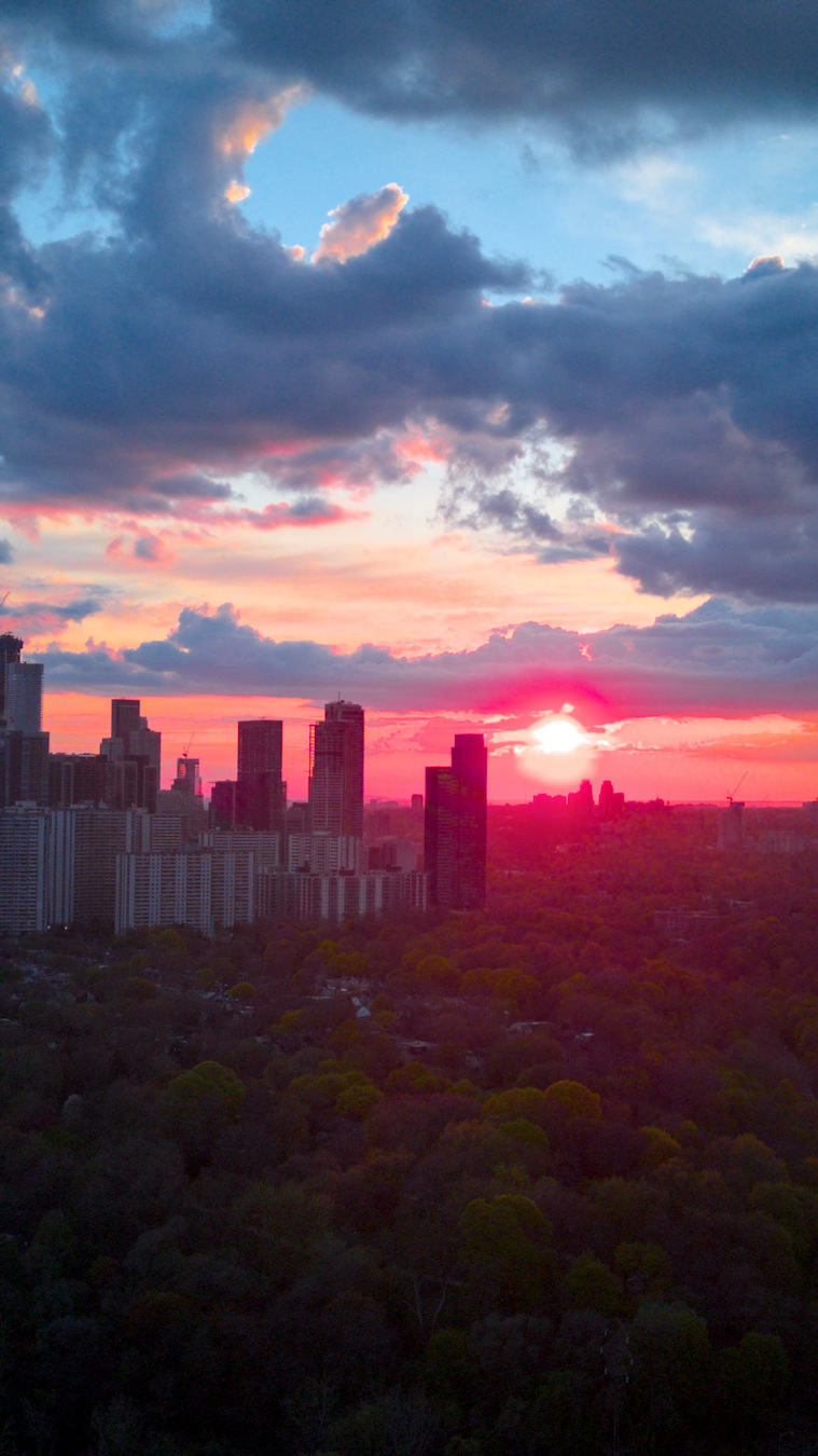 Toronto skyline at sunset with dramatic cloud cover.