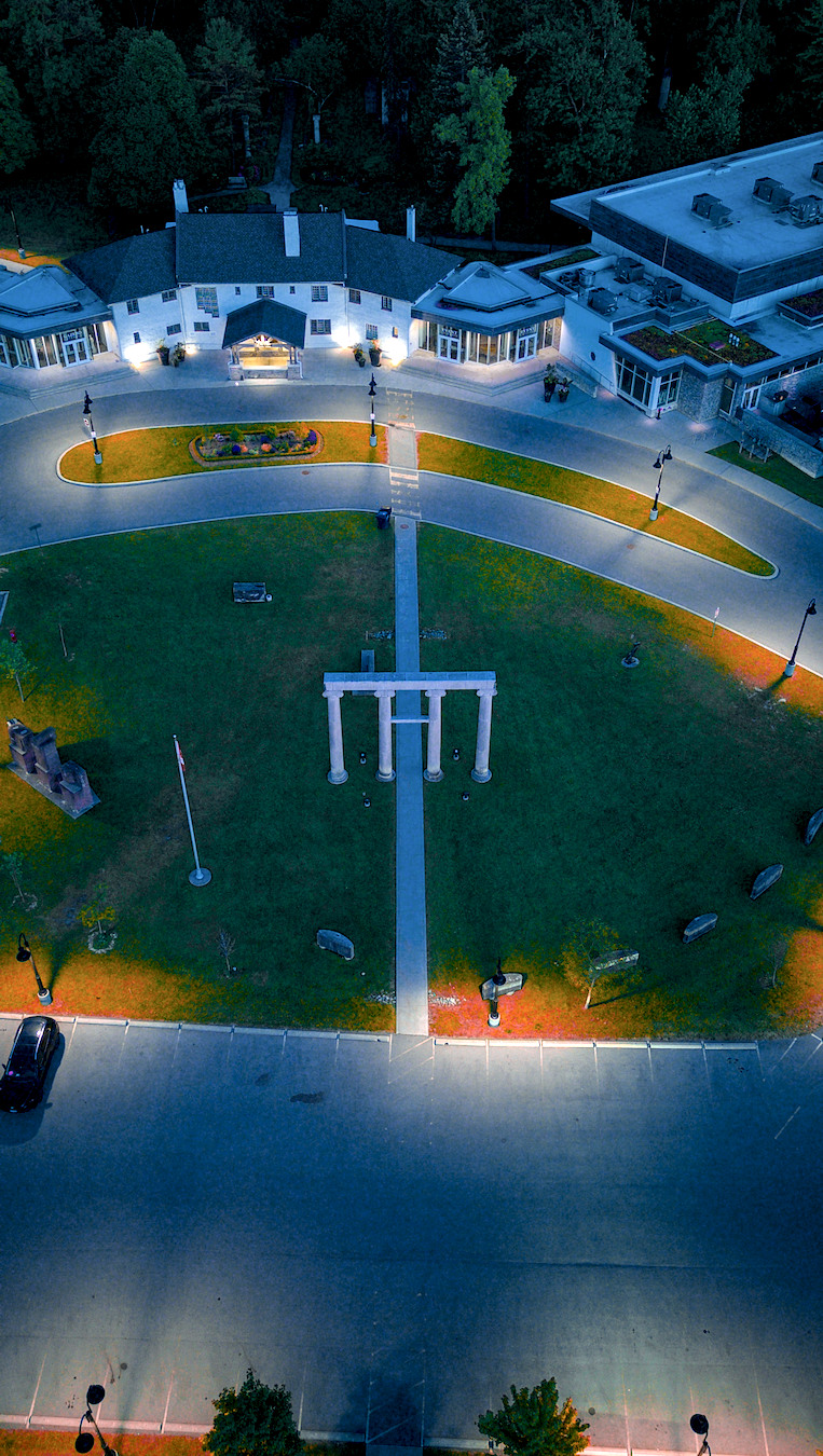Architectural estate aerial with strong symmetry and landscaped grounds.